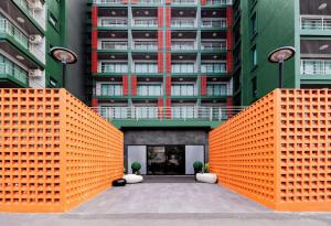 an orange fence in front of a building at The Grand Palm Villa in Ban Bang Phrao