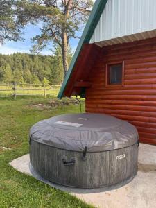 a large round rubber tub sitting next to a building at Zabljak_vikendica in Žabljak