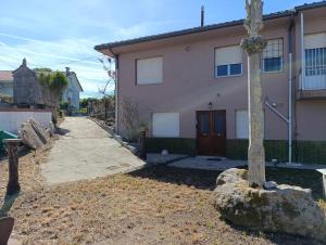 a house with a cross in front of it at Sálvora, Illas da Pousa in Ribeira +5 photos