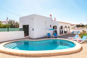 a villa with a swimming pool in front of a house at Villa Dulcesol by Villa Select in Alaior