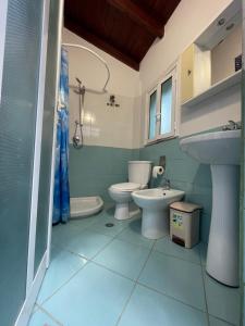 a bathroom with two toilets and a sink at Sinan moraci in Dukat +28 photos