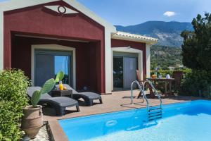 a patio with a swimming pool and a house at Trapezaki Bay Cottage in Trapezaki