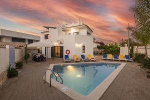 a villa with a swimming pool in front of a house at Villa Miramar Gale by Villa Select in Galé