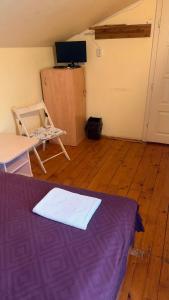 a room with a bed and a table and a tv at Stara Praha Loft Rooms in Uzhhorod