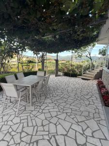 a patio with a table and chairs and stairs at Fortress Apartment in Bar