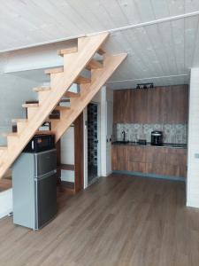 a kitchen with a wooden staircase in a house at zatyshnyy dvoryk Затишний Дворик in Kolomiya