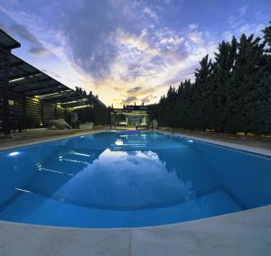 a large blue swimming pool in front of a building at Private Pool House for 6 by Olivujoj in Anavyssos