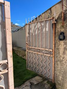 a gate on the side of a fence at L'Echappée Verte Climatisée in Marvejols