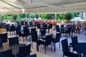 a group of tables and chairs in a patio at Imperial Hotel&Spa - Baile Olanesti in Băile Olăneşti