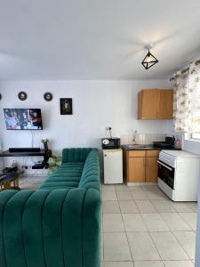 a living room with a green couch in a kitchen at Luxe Haven in Nairobi