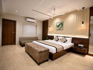 a bedroom with a large bed and a couch at Evara-Meraki Inn in Kolkata