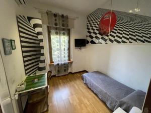 a room with a bed and a table in it at Affittacamere Pavia in Pavia