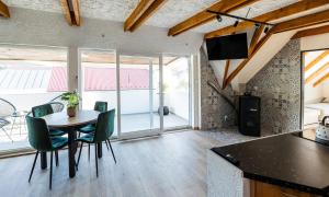 a kitchen and dining room with a table and chairs at Tarasova in Zbudský Rokytov