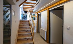 a hallway with wooden stairs in a house at Tarasova in Zbudský Rokytov