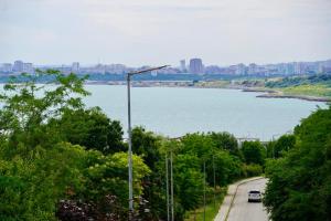 a street light on the side of a road next to a river at Marina Sarafovo by Cosher in Burgas