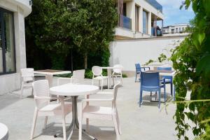 a group of tables and chairs sitting on a patio at Marina Sarafovo by Cosher in Burgas