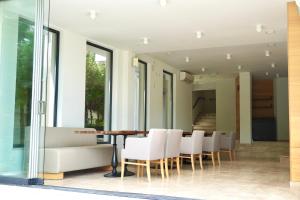 a dining room with a table and white chairs at Marina Sarafovo by Cosher in Burgas +96 photos