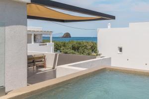 a view of the ocean from a house with a swimming pool at Ostria Vento in Pollonia