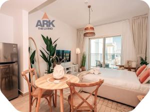 a bedroom with a bed and a table and chairs at Ark Living Stay in Yas Island in Yas Island