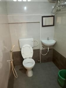 a bathroom with a toilet and a sink at Arrow mansion in Kolli Hills