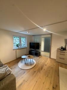 a living room with a table and a couch at Casa Souterrain in Immenstaad am Bodensee