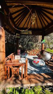 a table and a chair under a pavilion at le frangipanier in Le Barroux