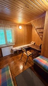 a room with a table and a bench in a cabin at Stara Praha Loft Rooms in Uzhhorod