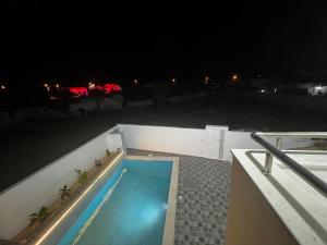 a swimming pool on top of a building at night at Villa baya in Djerba