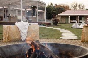 a fire pit with a horse in a yard at Amadiya Port Arthur Villas in Port Arthur