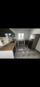 a large kitchen with stainless steel appliances in a room at Villa baya in Djerba +3 photos