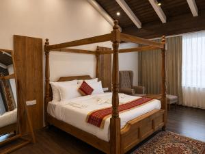 a bedroom with a wooden bed with a wooden frame at The himalayan chester in Manāli