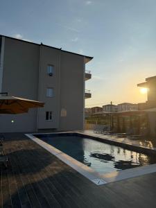 a large swimming pool on the side of a building at Arkej Pool Aparthotel in Golem