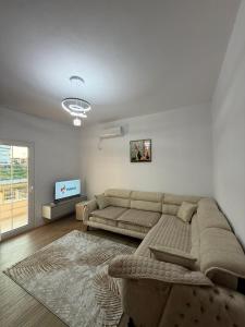 a living room with a couch and a flat screen tv at Arkej Pool Aparthotel in Golem