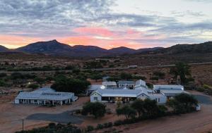 an aerial view of a house with mountains in the background at Kamieskroon Hotel in Kamieskroon
