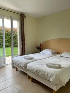 a bedroom with two beds and a large window at French country home II in Les Forges +43 photos