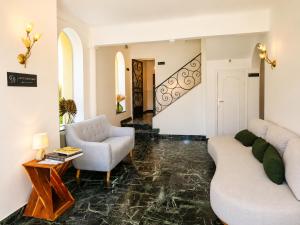 a living room with a couch and a chair and a table at La Garoupe-Gardiole Boutique Hotel in Antibes +29 photos