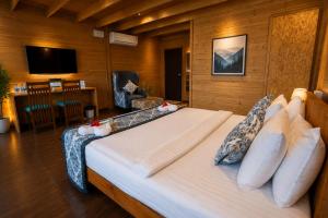 a bedroom with a large bed in a room at The Blossom Resort - Chikmagalur in Chikmagalūr