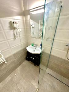 a bathroom with a sink and a shower at Mario Summerland Property in Mamaia