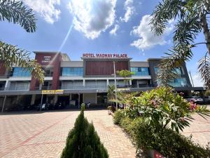 a building with a sign that reads hotel miami palace at Hotel Madhav Palace in Māndvi