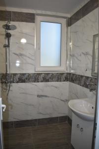 a bathroom with a sink and a window at Апартамент за гости Лале in Lovech +54 photos