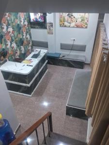 an empty room with tables and chairs in it at HOTEL KRISHNAM Inn in Mathura +2 photos