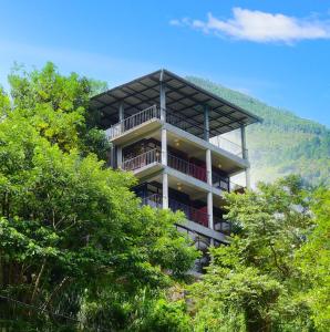 a building on top of a hill with trees at Viewfront Ella in Ella