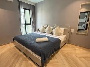 a bedroom with a bed with a towel on it at The Legendary Bang Tao 2-bedrooms apart #402 in Bang Tao Beach