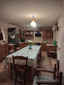 a kitchen with a table with chairs and a refrigerator at Dom Borowski in Bukowiec