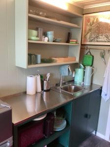 a kitchen with a sink and a counter top at Fagertun in Lillesand