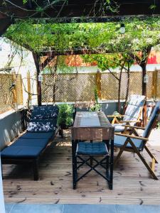 two chairs and a table and chairs under a pergola at Apartment Michail in Skála Nikíta