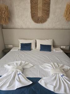 a white bed with two white towels on it at Византия in Sozopol