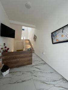 a living room with a television and a marble floor at Corte Moscara Vasto Centro in Vasto