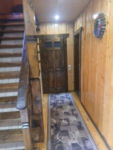 an empty room with a staircase and a wooden door at Верх Довбуша in Vorokhta