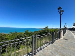 a street light on a fence with the ocean in the background at Corte Moscara Vasto Centro in Vasto